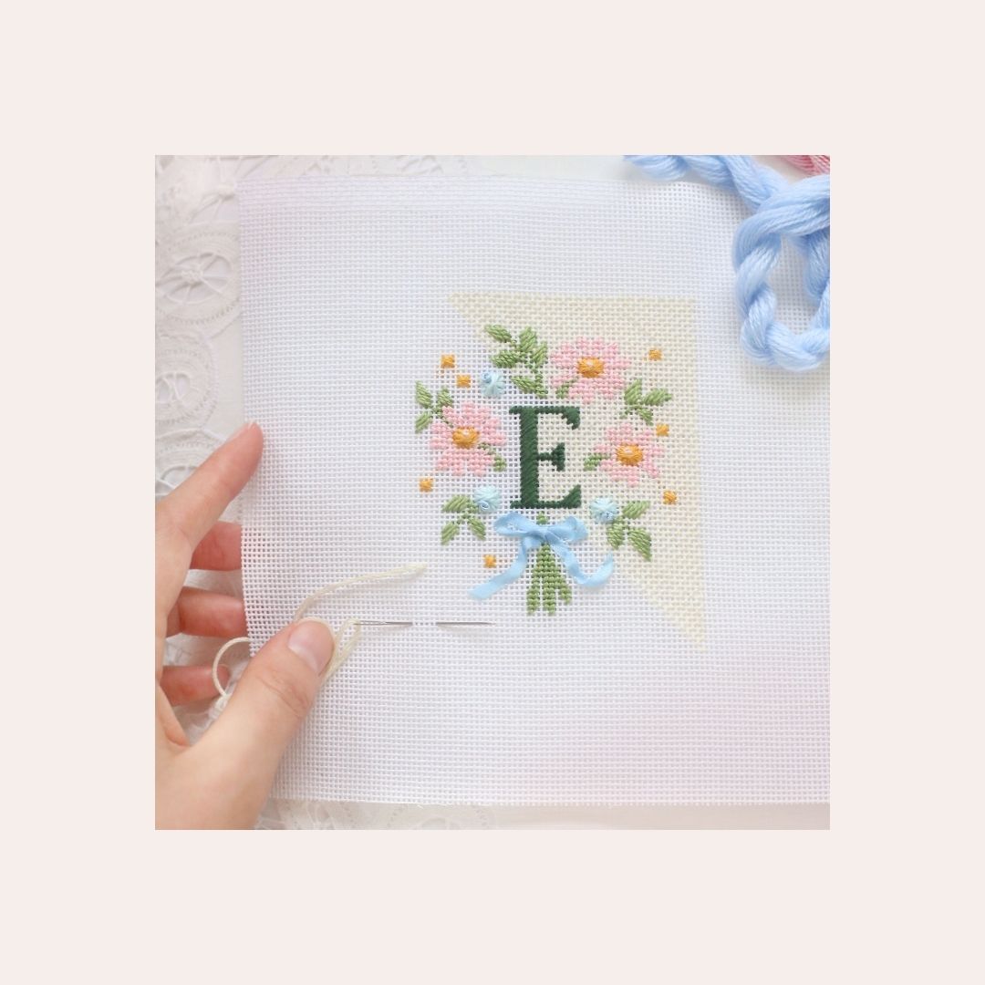 Almost completed Wildflower Field - Three Charted Monograms project with the letter E.