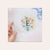 Almost completed Wildflower Field - Three Charted Monograms project with the letter E.