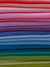 Several colored velvet fabrics are stacked on top of each other. Velvet fabric for self finishing needlepoint. 
